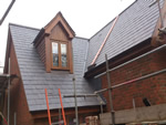Reroofing with natural slate tiles throughout the New Forest from Harris Roofing Limited.