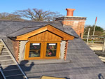 Reroofing with natural slate tiles throughout the New Forest from Harris Roofing Limited.