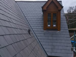 Reroofing with natural slate tiles throughout the New Forest from Harris Roofing Limited.