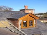 Reroofing with natural slate tiles throughout the New Forest from Harris Roofing Limited.