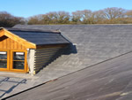Reroofing with natural slate tiles throughout the New Forest from Harris Roofing Limited.