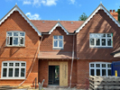 Machine made tiles hung on building face and roof fixed Harris Roofing Limited.