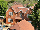 Machine made tiles hung on building face and roof fixed Harris Roofing Limited.