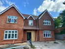 Machine made tiles hung on building face and roof fixed Harris Roofing Limited.