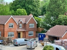Machine made tiles hung on building face and roof fixed Harris Roofing Limited.