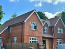 Machine made tiles hung on building face and roof fixed Harris Roofing Limited.