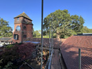 Reroofing with handmade tiles, incorporation of flat roof system