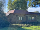 Reroofing with handmade tiles, incorporation of flat roof system